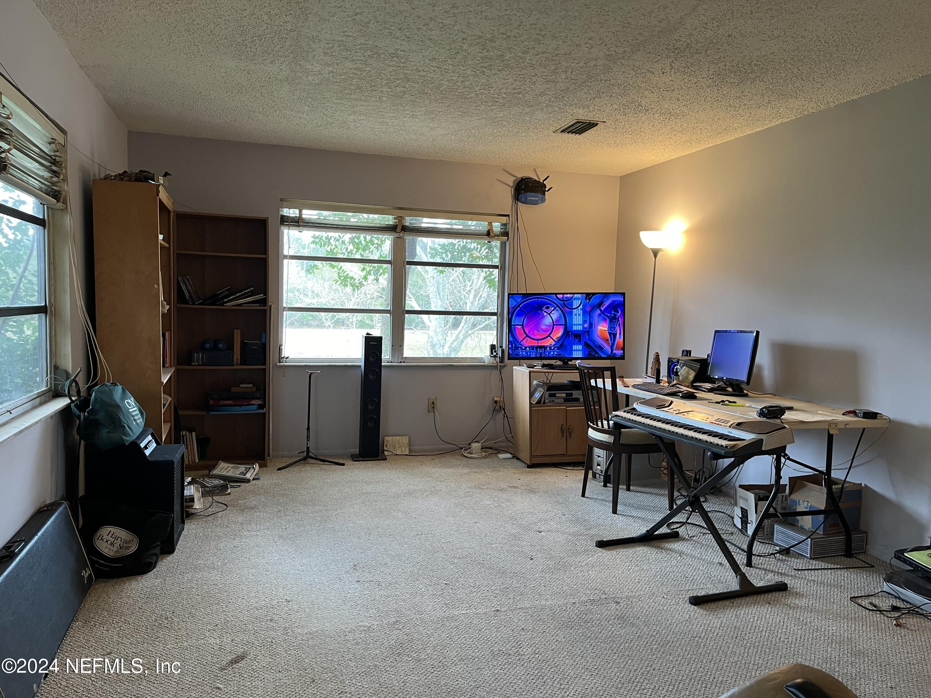 228 Lily Road St. Augustine, FL 32086 - Photo 6 of 34 a view of a workspace with furniture and a window