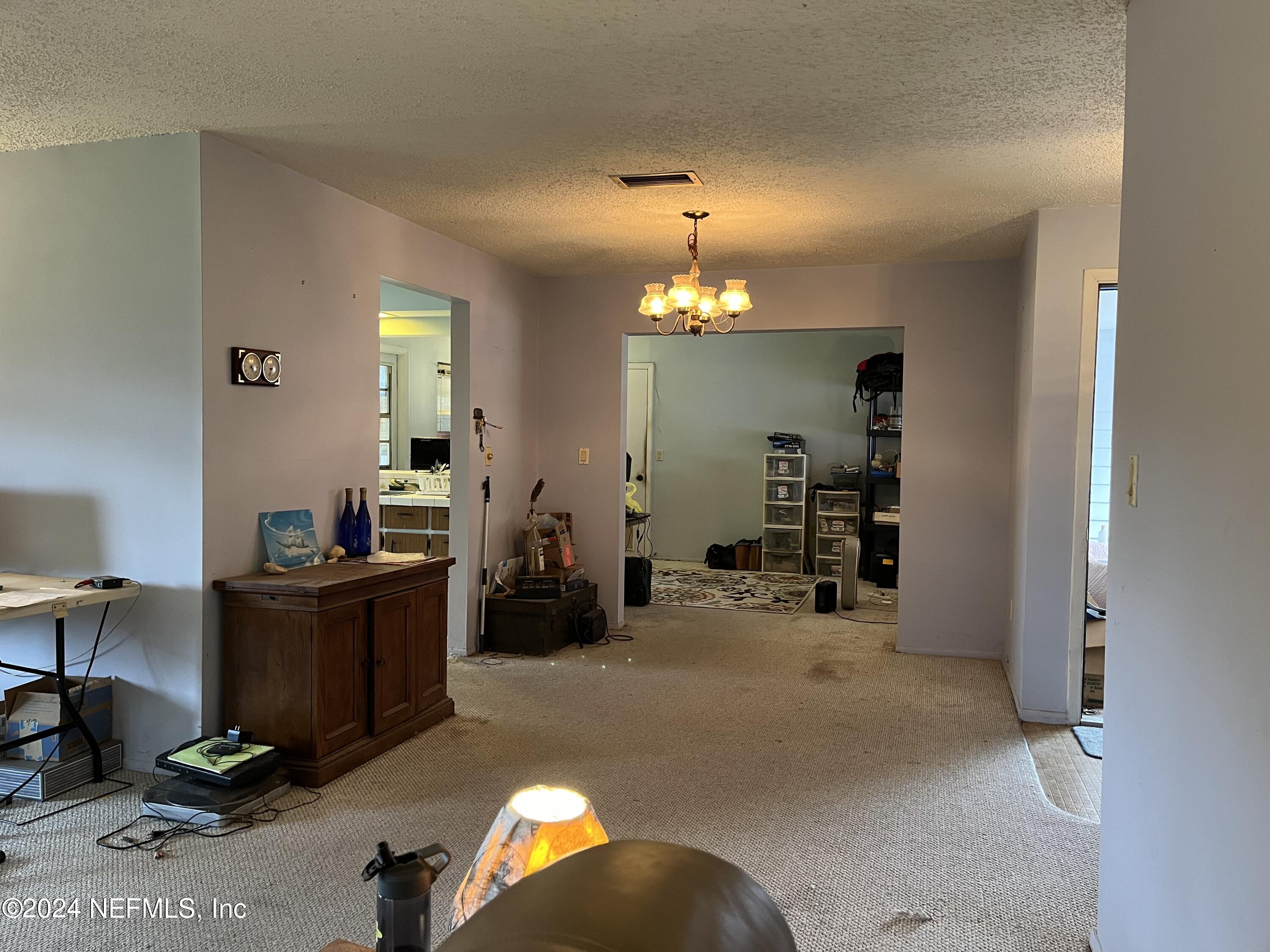 228 Lily Road St. Augustine, FL 32086 - Photo 7 of 34 a view of a workspace with furniture and a lamp