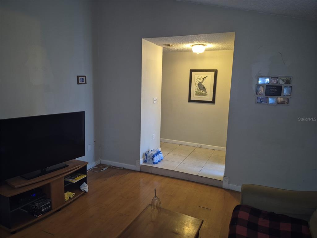 13710 Whitby Road Hudson, FL 34667 - Photo 3 of 21 a living room with furniture and a flat screen tv