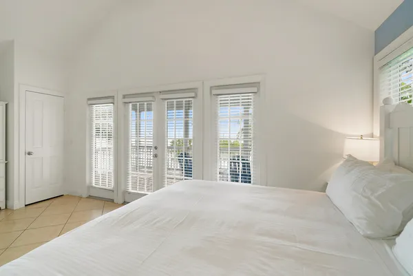 a large bed sitting in a bedroom next to a window