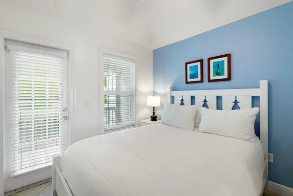 a bedroom with bed and a large window