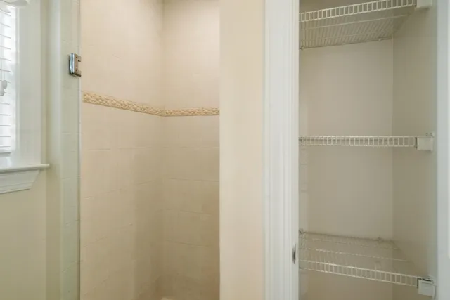 a large bed sitting in a bedroom next to a window