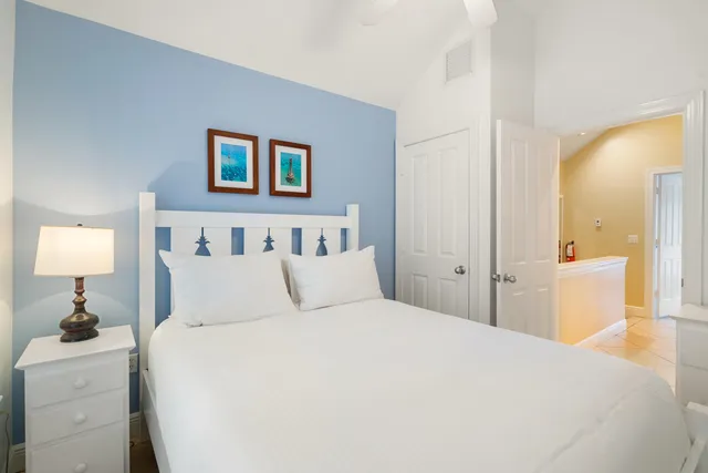 a bedroom with bed and a large window