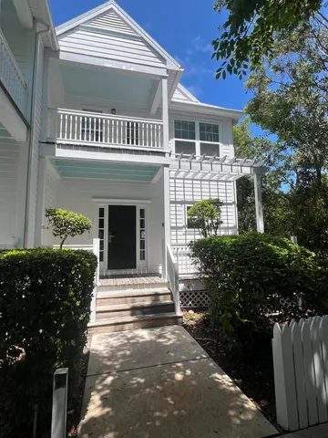 a view of a swimming pool with a lawn chair and palm trees