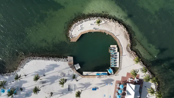 a view of a house with a yard and potted plants