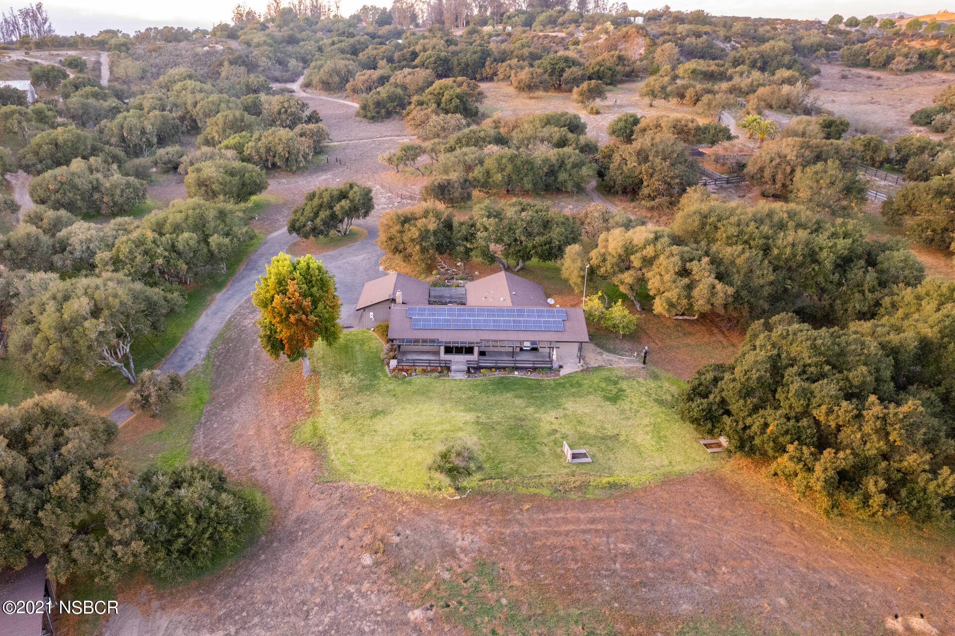 an aerial view of a house with a yard