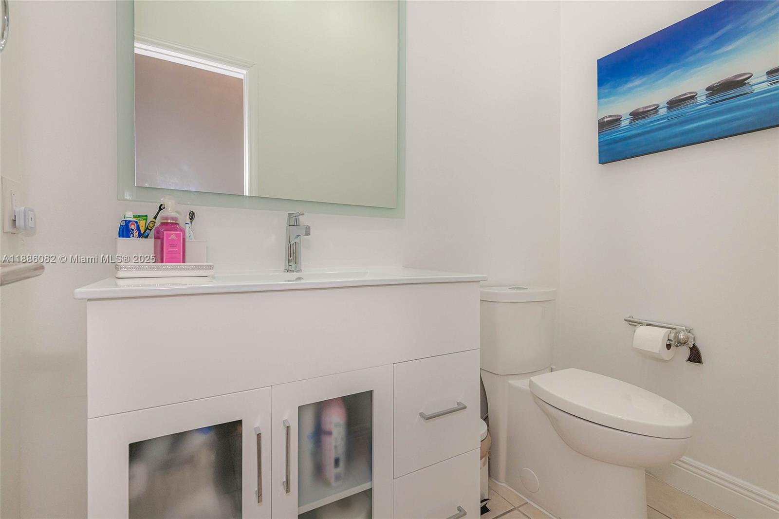 2911 Southwest 149th Place Miami, FL 33185 - Photo 21 of 33 a bathroom with a sink a toilet and mirror