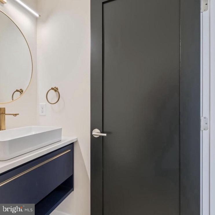 6931 River Drive Road Sparrows Point, MD 21219 - Photo 23 of 54 Sleek modern bathroom with elegant accents.