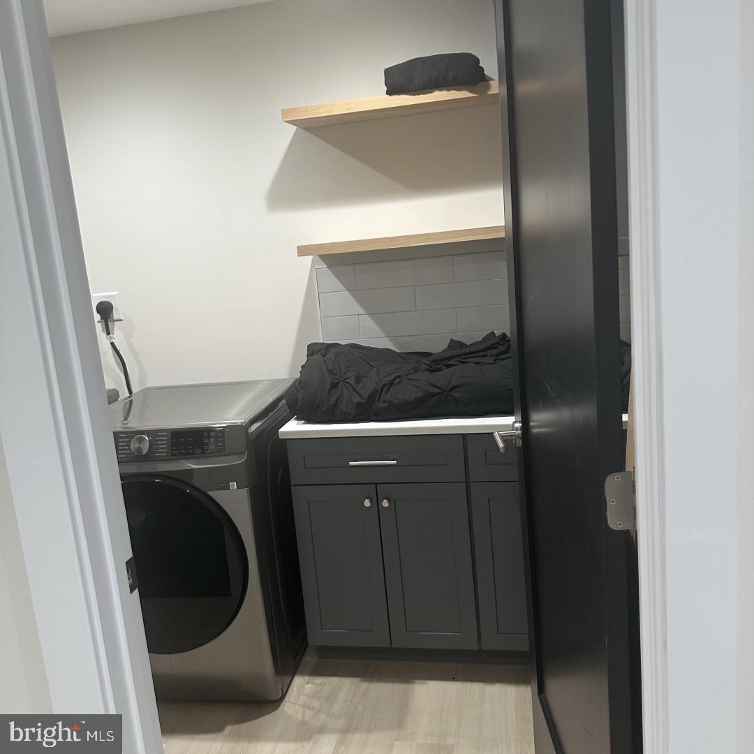 6931 River Drive Road Sparrows Point, MD 21219 - Photo 24 of 54 Modern laundry space with sleek design.