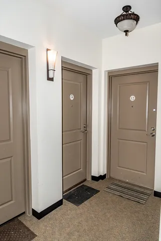 an empty room with windows and cabinet