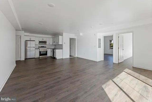 a view of a kitchen with a sink and a refrigerator