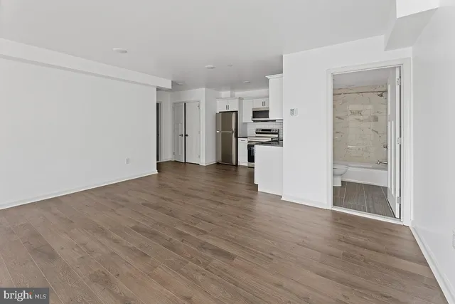 a view of a kitchen with wooden floor