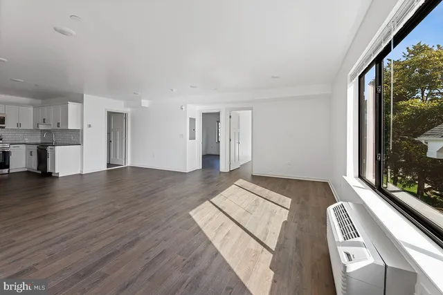 a view of kitchen with sink and wooden floor