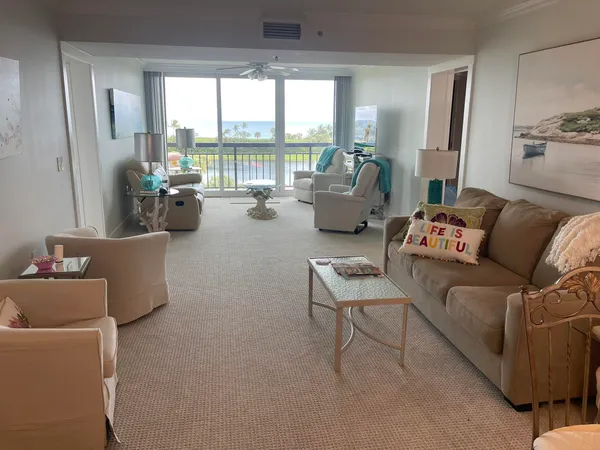 a living room with furniture and a floor to ceiling window