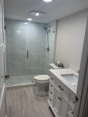 a bathroom with a toilet and a shower