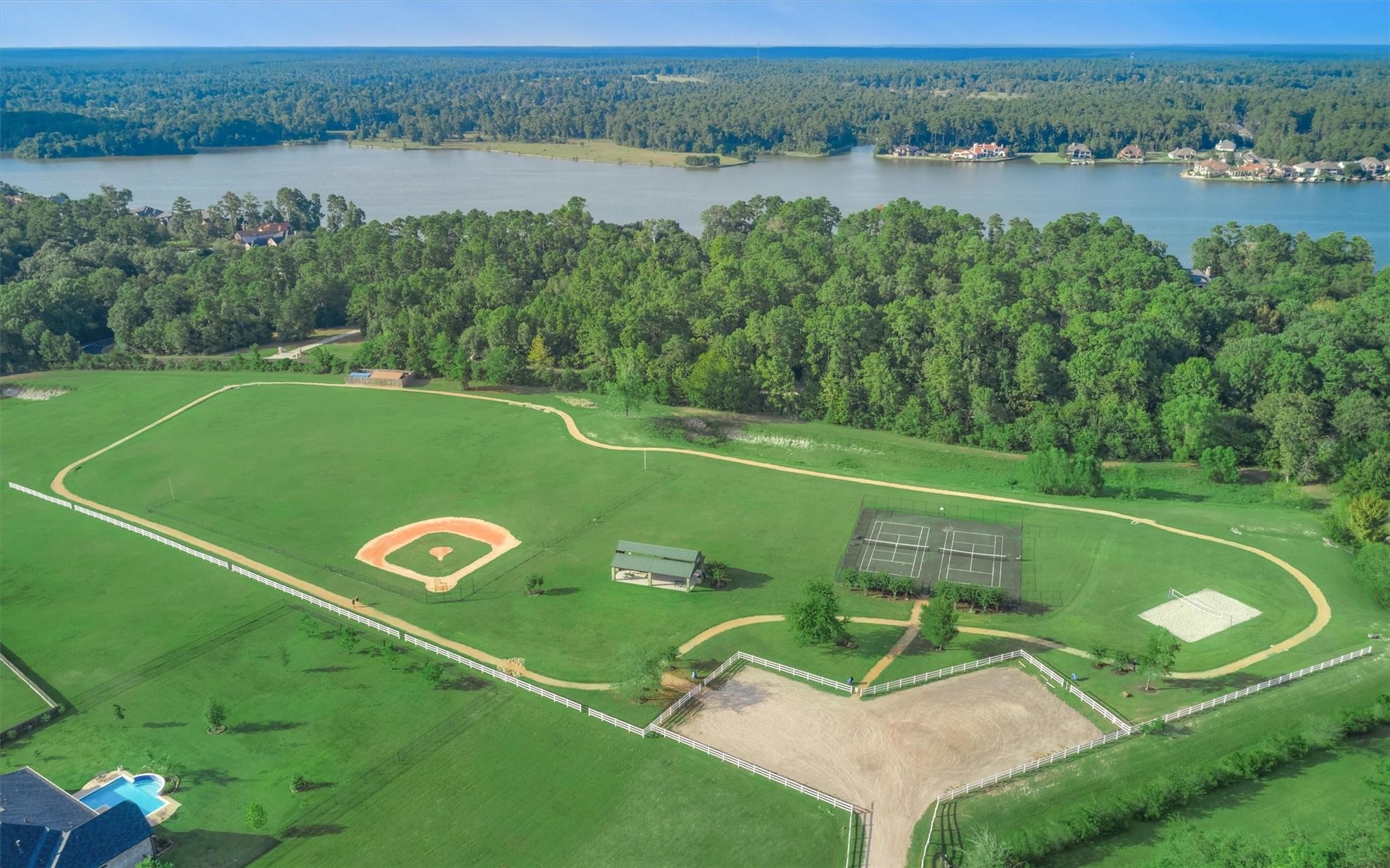 11618 Renaissance Drive Montgomery, TX 77356 - Photo 46 of 49 Grand Harbor residents enjoy Gregson Park- complete with walking trail, practice baseball diamond, covered pavilion for community events, tennis and pickleball courts and sand volleyball area. Lake Conroe can be seen beyond.