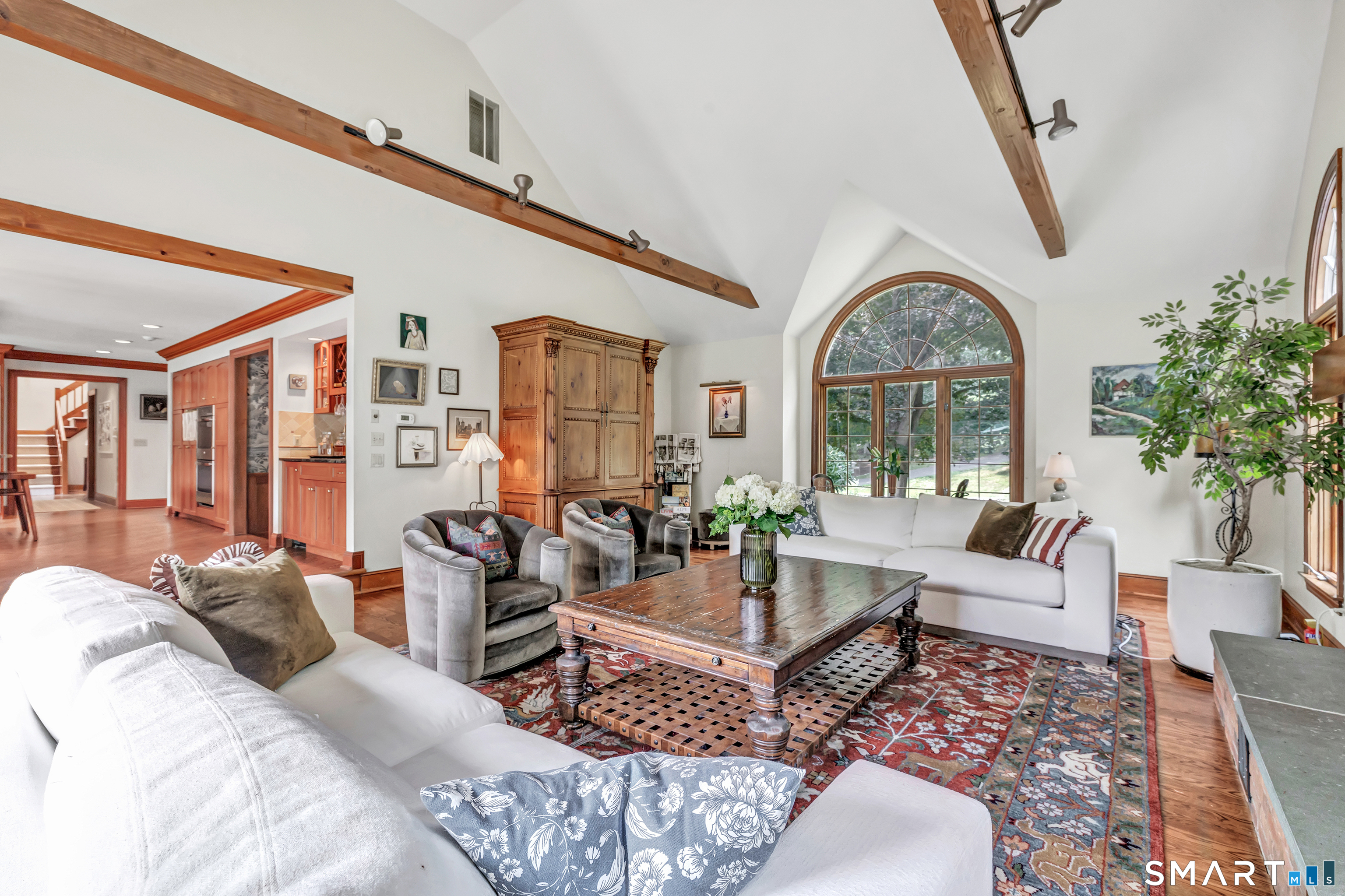 17 Plumtrees Road Newtown, CT 06470 - Photo 13 of 40 Adjacent to the Kitchen is the expansive Great Room with soaring ceiling, beautiful wooden beams and wood burning fireplace. Incredible windows that bring the outside in...
