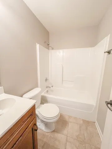 a bathroom with a toilet a sink and bathtub