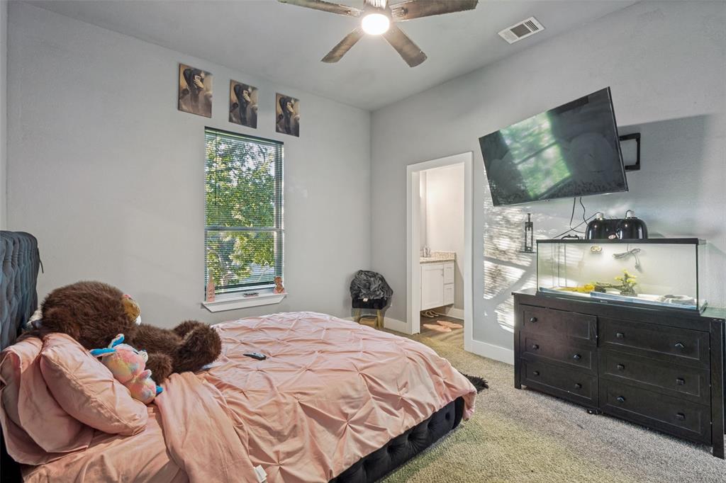 7909 Ivory Lane Dallas, TX 75216 - Photo 15 of 20 a bedroom with a bed window and wall painting