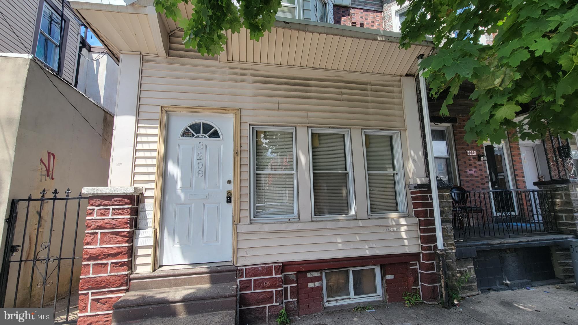 3208 D Street Philadelphia, PA 19134 - Photo 15 of 33 a front view of a house with a tree