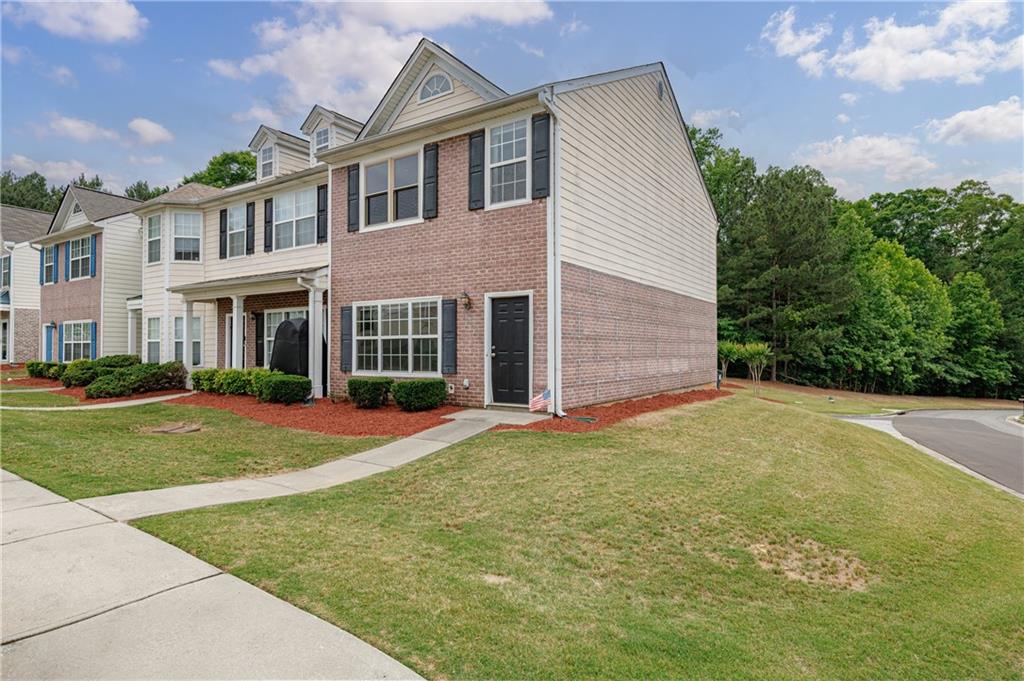 4203 Legacy Square Atlanta, GA 30349 - Photo 2 of 35 a front view of a house with a yard and garage