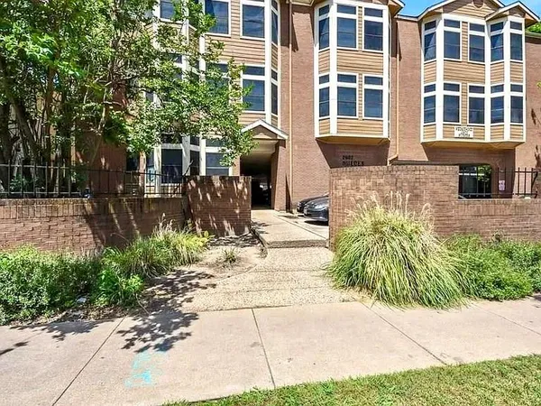 a front view of a building with garden