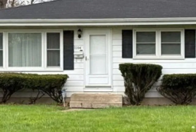 a front view of a house with a yard table and chairs