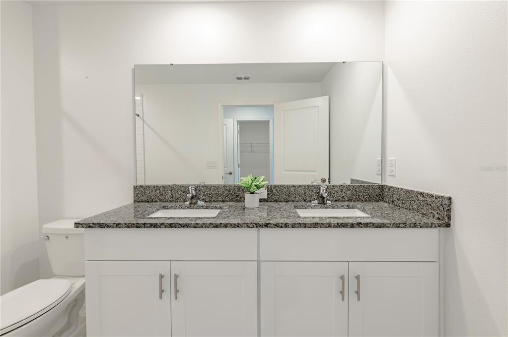 21395 Darter Road Land O' Lakes, FL 34638 - Photo 11 of 22 a bathroom with a granite countertop sink and a mirror