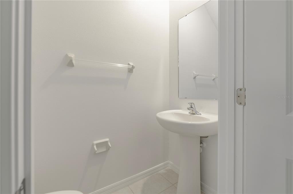 21395 Darter Road Land O' Lakes, FL 34638 - Photo 8 of 22 a bathroom with a sink and mirror