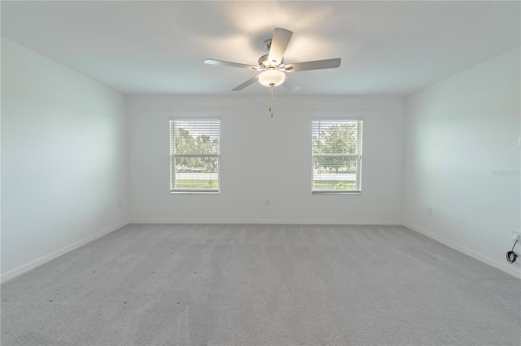 21395 Darter Road Land O' Lakes, FL 34638 - Photo 9 of 22 an empty room with windows and fan