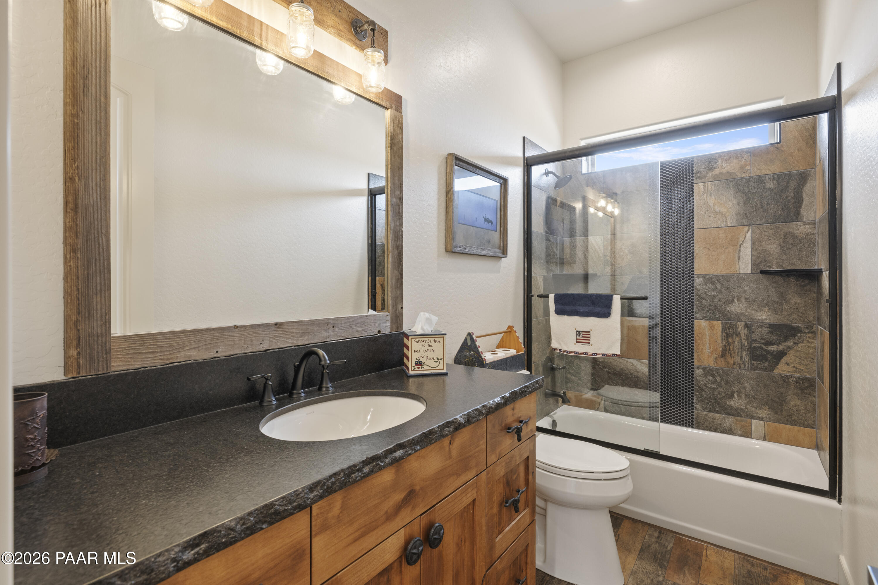 1399 East Western Way Paulden, AZ 86334 - Photo 27 of 44 a bathroom with a granite countertop sink toilet a mirror a glass door and shower