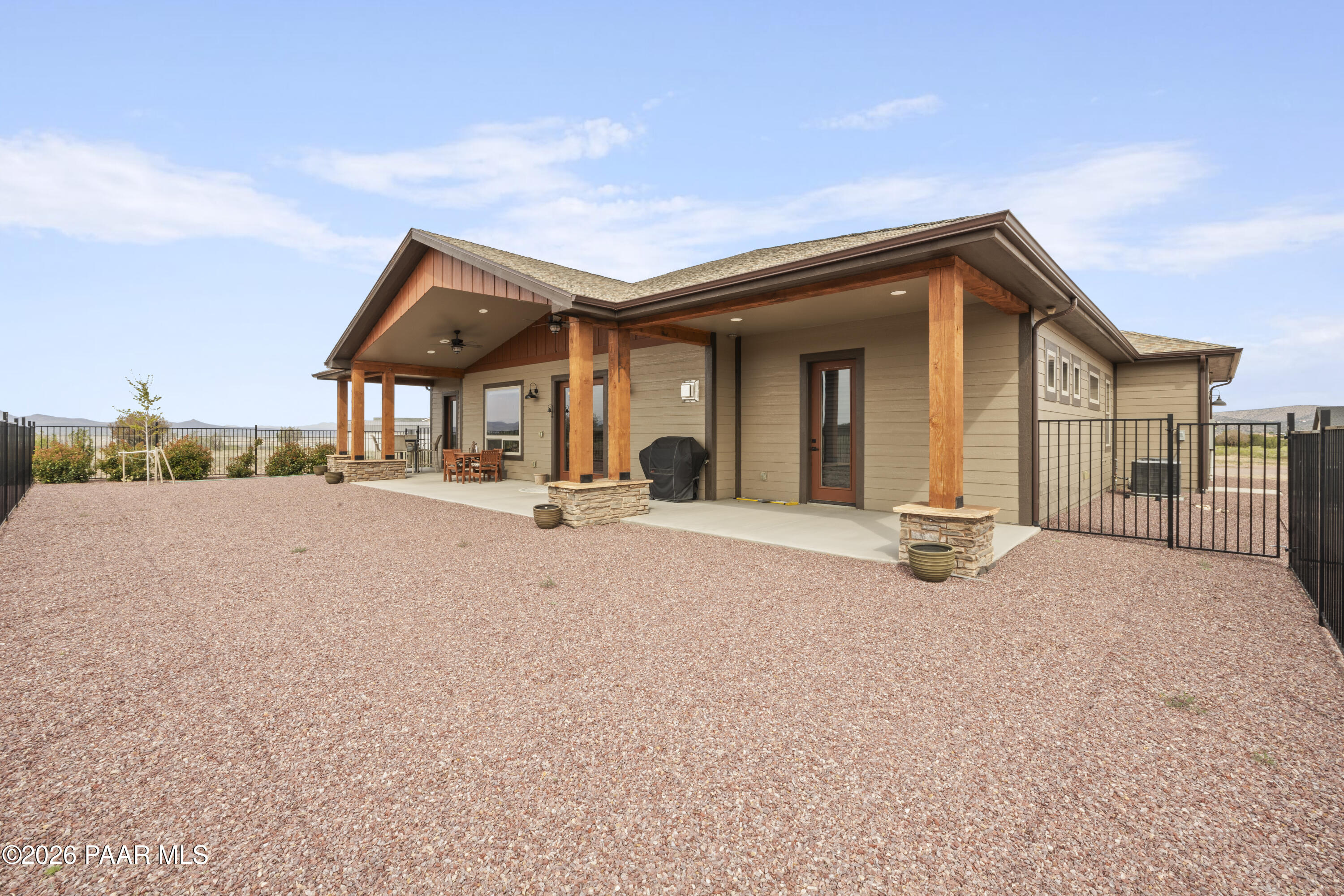 1399 East Western Way Paulden, AZ 86334 - Photo 34 of 44 a palm tree is sitting in front of a house with a yard