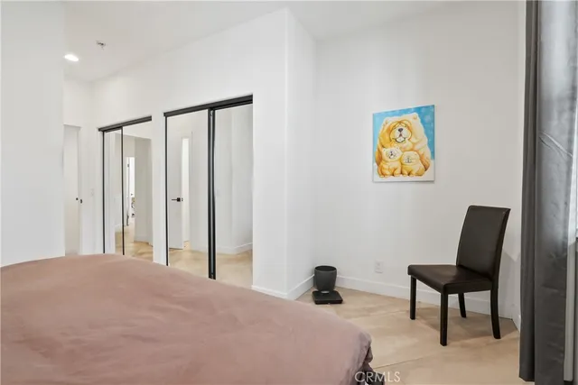 a bedroom with a bed and painting on the wall