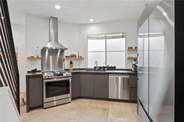 a kitchen with stainless steel appliances granite countertop a stove and a refrigerator