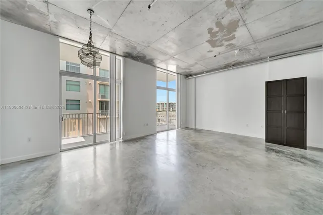 a kitchen with a refrigerator a stove and white cabinets