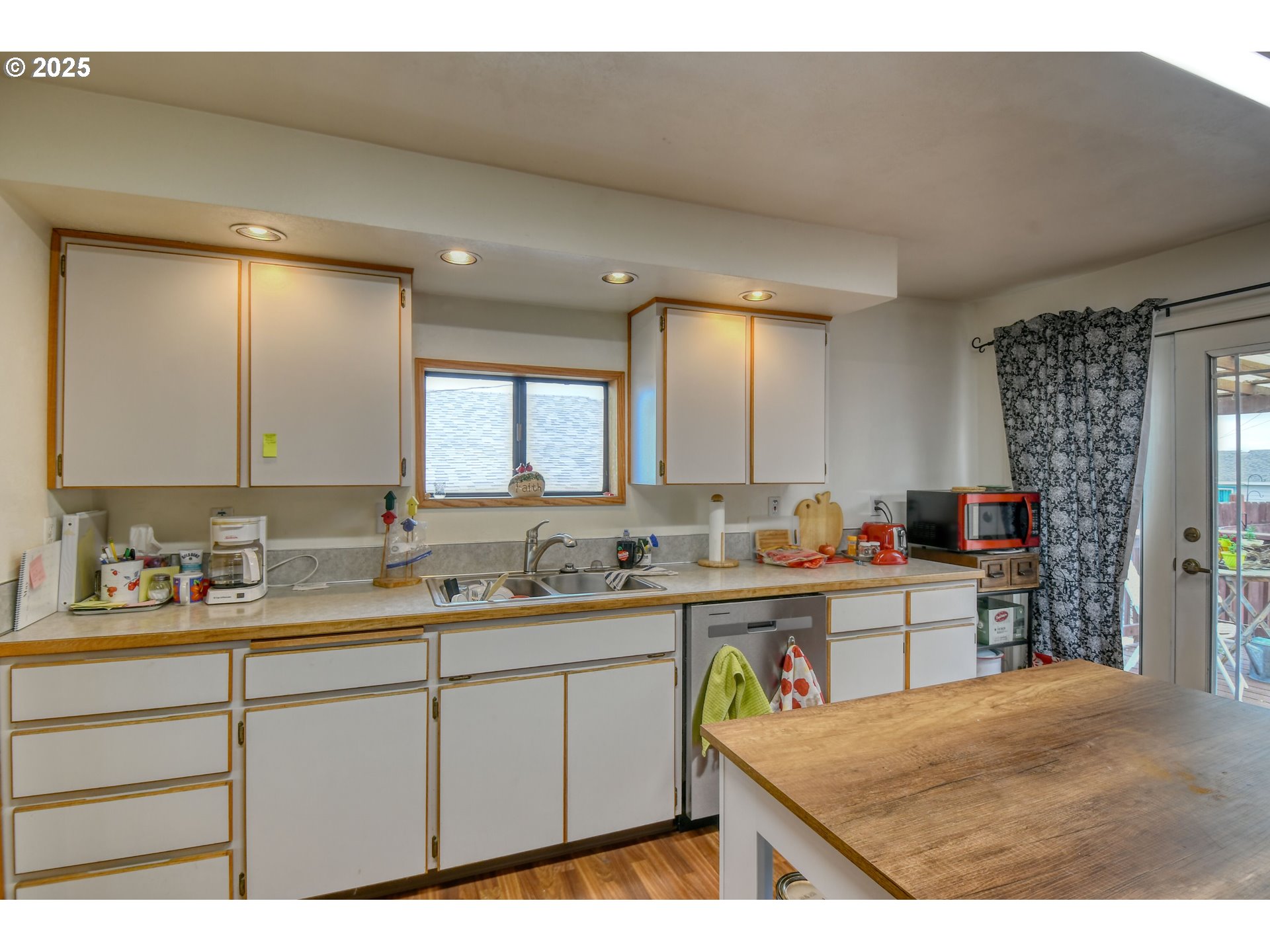 728 Southeast 6th Street Pendleton, OR 97801 - Photo 8 of 34 a kitchen with a sink a stove cabinets and counter space
