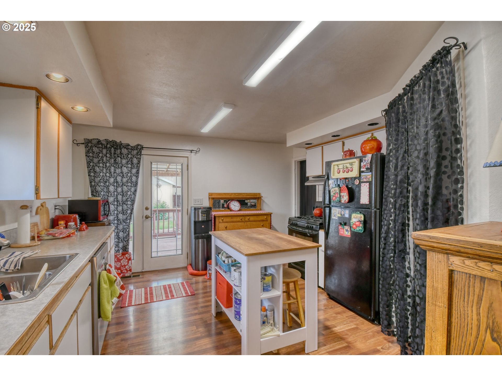 728 Southeast 6th Street Pendleton, OR 97801 - Photo 10 of 34 a kitchen that has a lot of cabinets a sink and a wooden floor