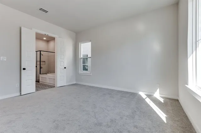 an empty room with windows and closet