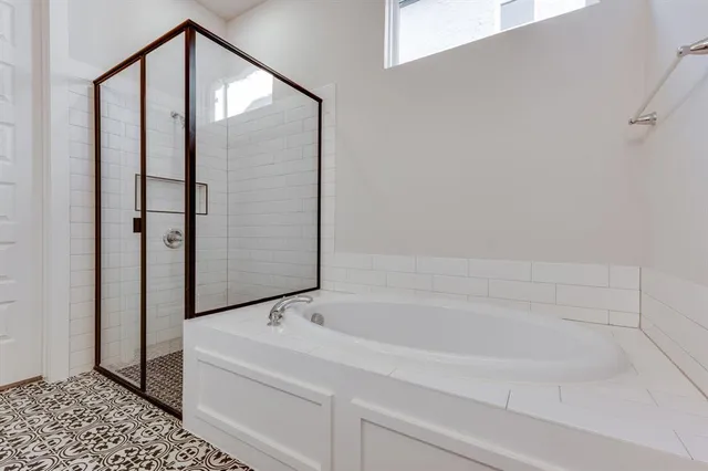 a bathroom with a bathtub and a shower
