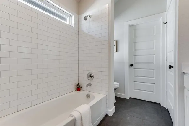 a bathroom with a bathtub and shower