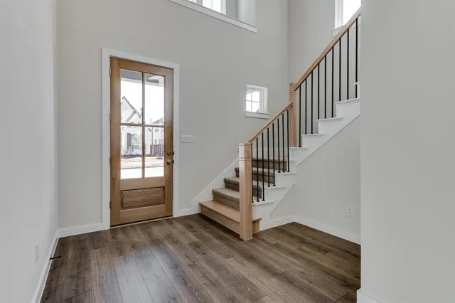 a view of entryway and hall with wooden floor
