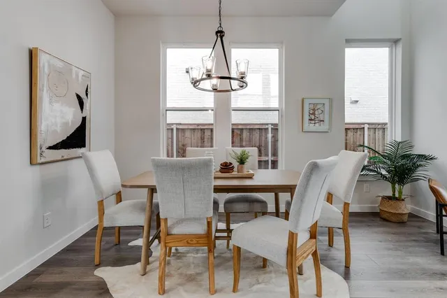 a dining room with furniture window and wooden floor