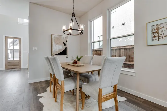 a view of a dining room with furniture wooden floor and chandelier