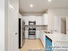 9426 Apple Ridge Lane, Unit 303 San Antonio, TX 78239 - Photo 15 of 25 a kitchen with stainless steel appliances granite countertop a refrigerator stove and sink