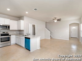 9426 Apple Ridge Lane, Unit 303 San Antonio, TX 78239 - Photo 2 of 25 a kitchen with kitchen island granite countertop a sink cabinets and stainless steel appliances