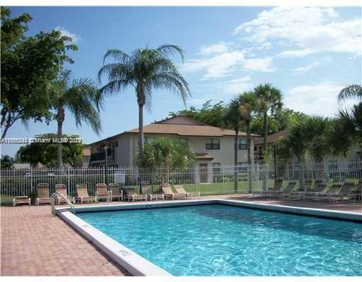 10057 Winding Lake Road, Unit 103 Sunrise, FL 33351 - Photo 12 of 13 a small pool covered with tall trees