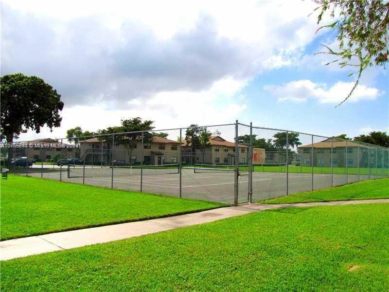10057 Winding Lake Road, Unit 103 Sunrise, FL 33351 - Photo 13 of 13 a view of field with tall trees