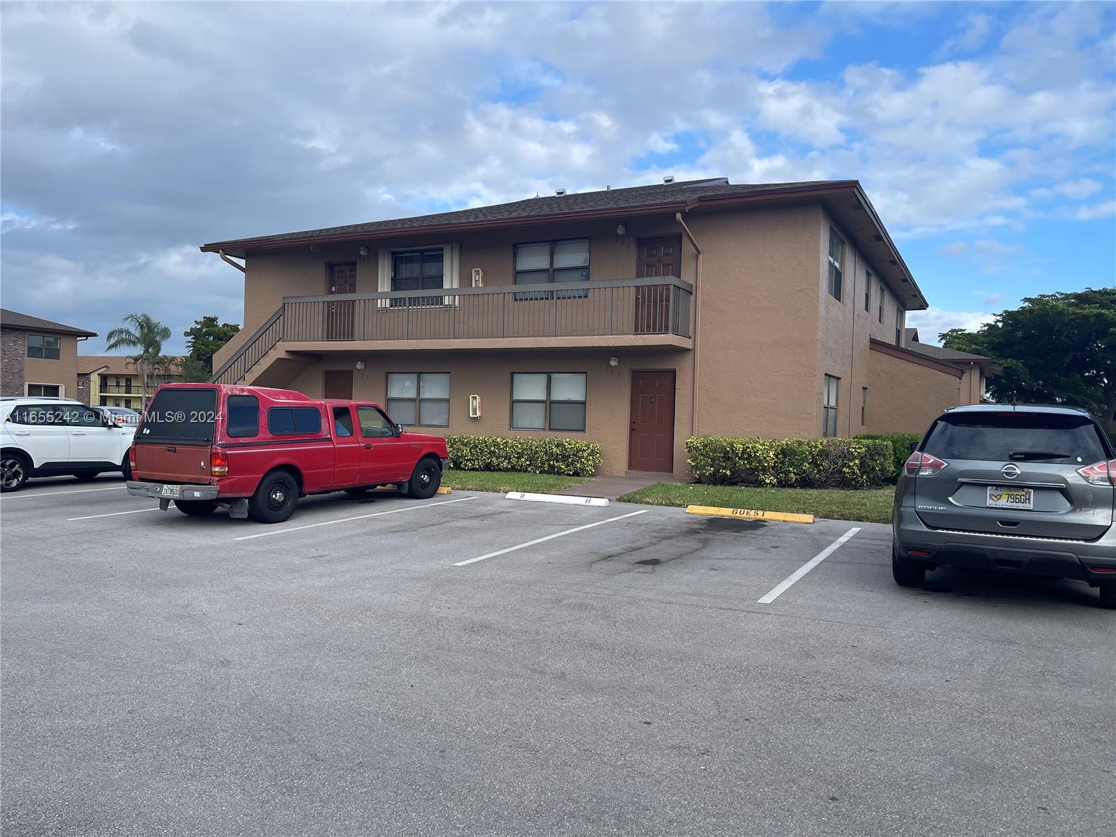 10057 Winding Lake Road, Unit 103 Sunrise, FL 33351 - Photo 3 of 13 a car parked in front of a house