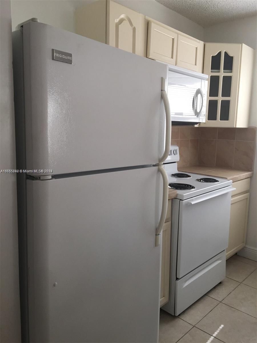 10057 Winding Lake Road, Unit 103 Sunrise, FL 33351 - Photo 6 of 13 a utility room with dryer and washer