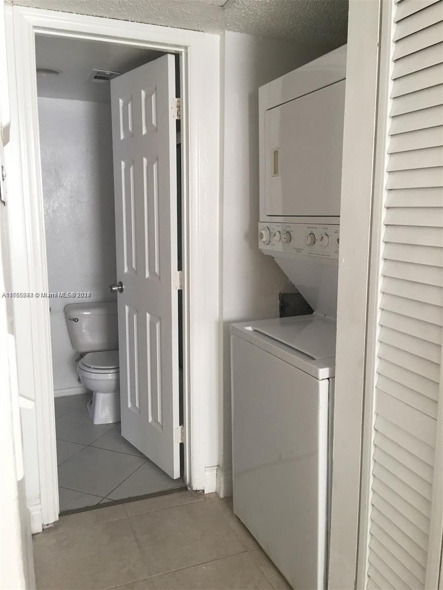 10057 Winding Lake Road, Unit 103 Sunrise, FL 33351 - Photo 7 of 13 a bathroom with a toilet and a sink